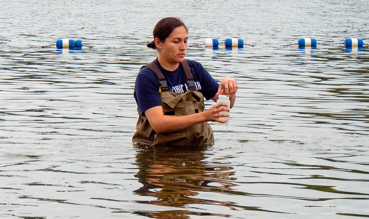 student collecting water sample