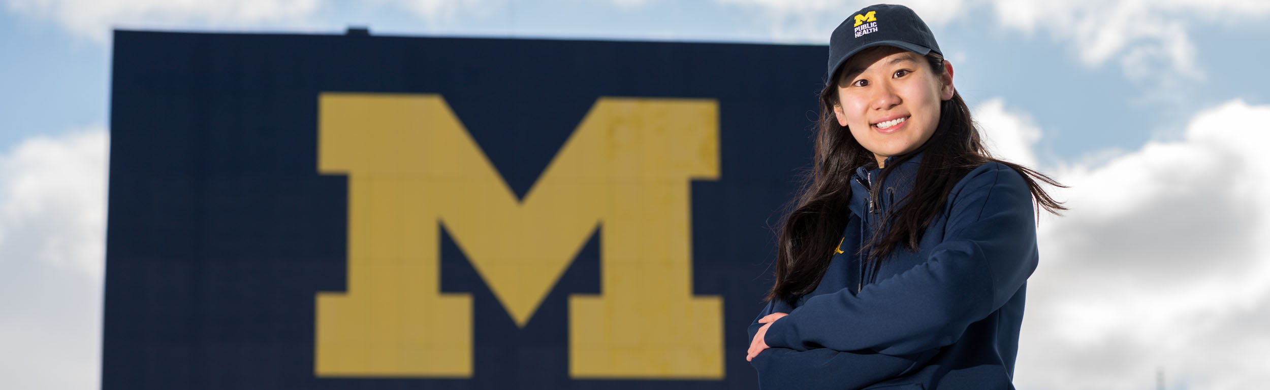 Michigan Public Health student in front of the Big House