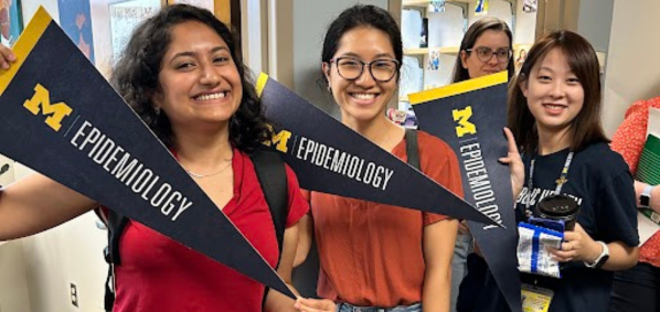Students holding EPID pennants