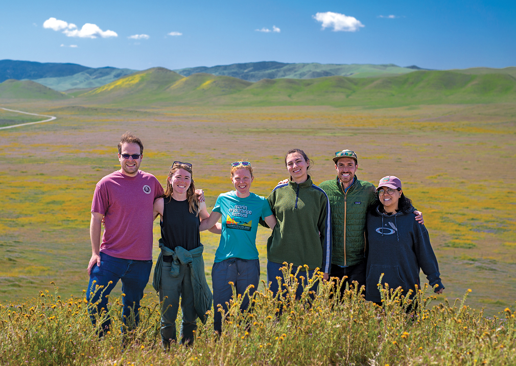 Jennifer Head, third from left, and a field research team pose at a field site in the Carrizo Plain National Monument in California during a super bloom. Rainfall following droughts fuels the growth of both California wildflowers and Coccidioides fungi in soils.