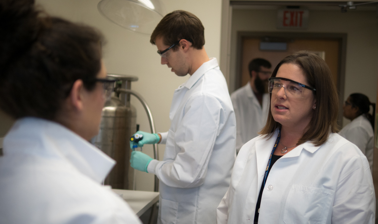 faculty member in lab with students