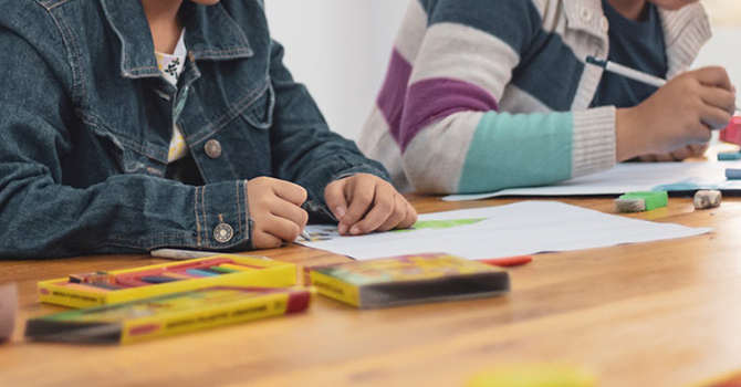 children coloring in classroom