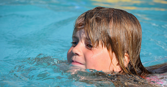 little girl swimming in pool