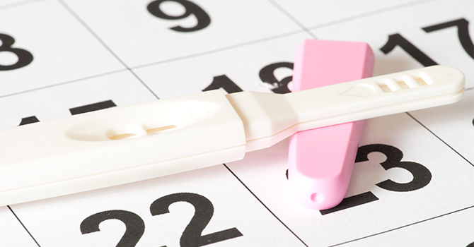 pregnancy test on top of calendar