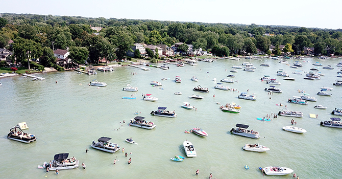 Boats and swimmers on Cass Lake, the largest and deepest lake in Oakland County. Cass Lake is in the northern Metro Detroit region of southeastern Michigan.