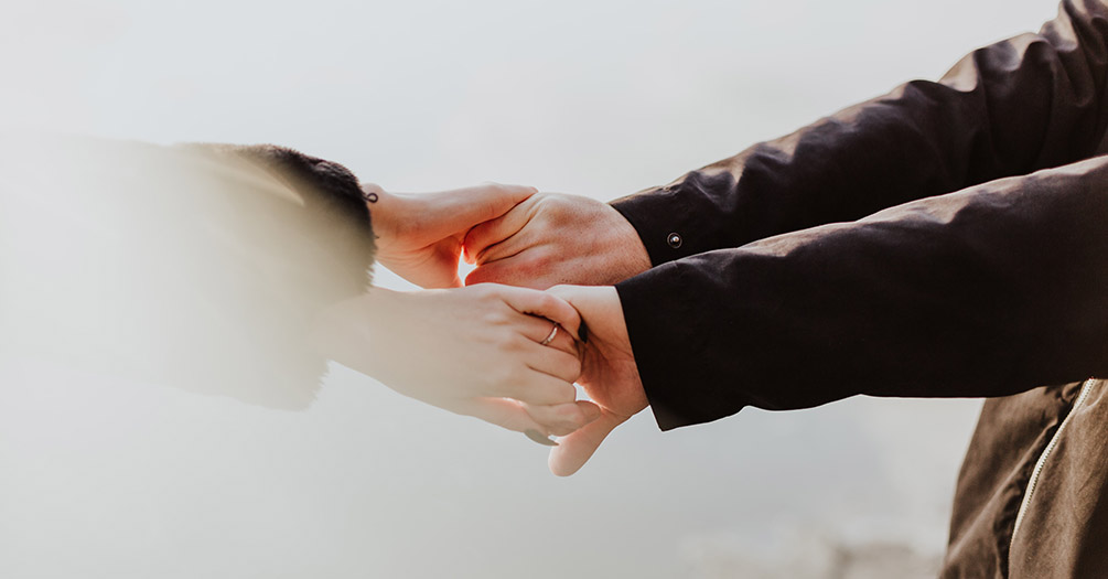 Two people holding hands.