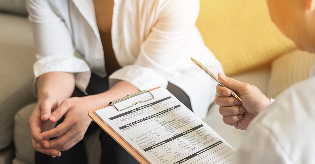 A doctor speaks to a woman.