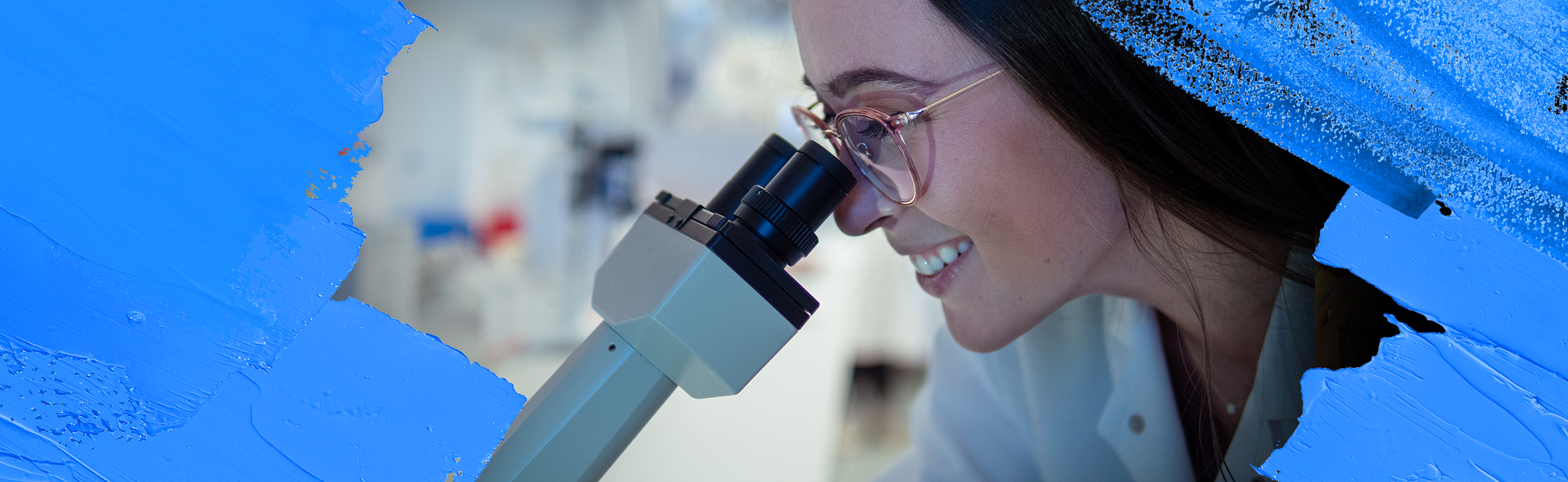 Epidemiology student looking through microscope
