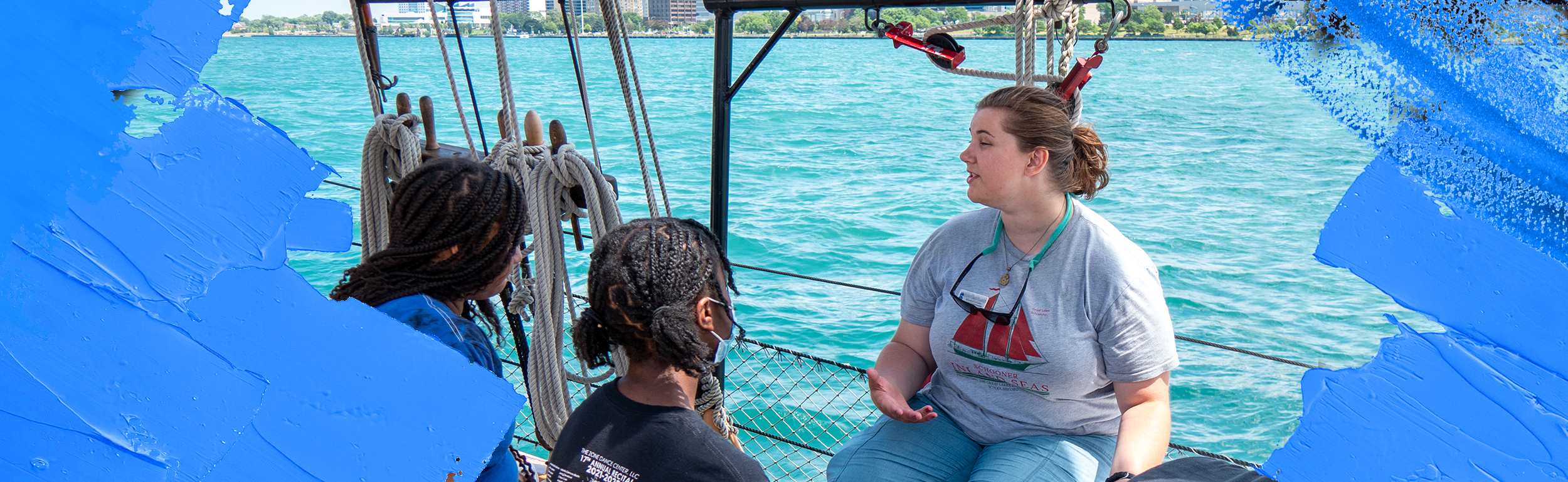 student on a boat talking to children