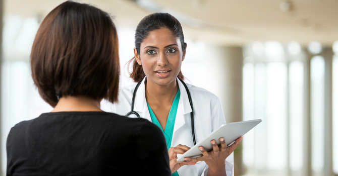 A provider goes over a health resource with a patient or parent